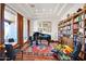 Comfortable living room showcasing a grand piano, bookshelves, and natural light at 8154 E Tecolote Cir, Scottsdale, AZ 85266