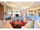 Bright living room with decorative fireplace, comfortable seating, and seamless access to the kitchen at 8154 E Tecolote Cir, Scottsdale, AZ 85266