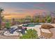 Inviting backyard pool area with desert landscaping, patio, lounge chairs, and privacy fence at 8154 E Tecolote Cir, Scottsdale, AZ 85266