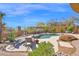 A landscaped yard features a pool, spa, outdoor seating, and privacy walls at 8154 E Tecolote Cir, Scottsdale, AZ 85266