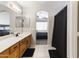 Bathroom featuring double sinks and an archway view to bedroom, neutral colors and lighting at 891 E Windsor Dr, Gilbert, AZ 85296