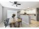 Bright dining area featuring a modern wood table, stylish chairs, neutral paint, and an open view into the kitchen at 891 E Windsor Dr, Gilbert, AZ 85296