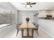 Cozy dining space featuring a wood table, modern chairs, neutral paint, and natural light from the window with blinds at 891 E Windsor Dr, Gilbert, AZ 85296