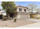 Charming two-story home featuring a tan exterior, well-maintained landscaping, and an attached two-car garage at 891 E Windsor Dr, Gilbert, AZ 85296