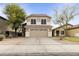 Traditional two-story home with a neutral color scheme, a two-car garage, and a low-maintenance desert front yard at 891 E Windsor Dr, Gilbert, AZ 85296