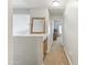 Hallway with carpet, storage and mirror, leading to rooms with natural lighting at 891 E Windsor Dr, Gilbert, AZ 85296