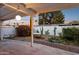 Charming back patio with string lights and privacy wall with mural, perfect for outdoor entertaining at 1009 E Bethany Home Rd, Phoenix, AZ 85014