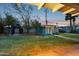 Lush backyard featuring mature trees, a gazebo, and a bonus structure for outdoor enjoyment at 1009 E Bethany Home Rd, Phoenix, AZ 85014