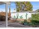 Charming backyard featuring a hammock, garden, and a wall with painted cacti at 1009 E Bethany Home Rd, Phoenix, AZ 85014