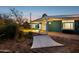 Backyard patio area with hammock, plants, and view of the home at 1009 E Bethany Home Rd, Phoenix, AZ 85014