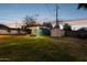 Backyard with a small studio, shed, and a well-manicured lawn at 1009 E Bethany Home Rd, Phoenix, AZ 85014