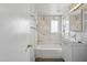 All white bathroom with marble shower and tub and vanity sink at 1009 E Bethany Home Rd, Phoenix, AZ 85014