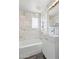 Bright bathroom features shower and a vanity with white marble tile at 1009 E Bethany Home Rd, Phoenix, AZ 85014