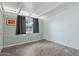 Well-lit bedroom with fresh paint, a window with curtains, and tiled floor at 1009 E Bethany Home Rd, Phoenix, AZ 85014