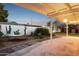 Relaxing covered patio area with a hammock and views of the landscaped backyard at 1009 E Bethany Home Rd, Phoenix, AZ 85014