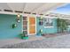 Up-close exterior showing a vibrant, orange front door and potted plants at 1009 E Bethany Home Rd, Phoenix, AZ 85014