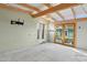 Bright living room with exposed beams, large windows, and access to the backyard at 1009 E Bethany Home Rd, Phoenix, AZ 85014