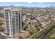 An aerial view of a modern high-rise building with surrounding neighborhood and mountain views at 1040 E Osborn Rd # 1801, Phoenix, AZ 85014