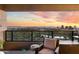 Balcony featuring views of a golf course, cityscape, and mountains at sunset at 1040 E Osborn Rd # 1801, Phoenix, AZ 85014