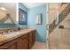 Modern bathroom featuring granite counters, wood cabinets, a vanity and a glass-enclosed shower at 1040 E Osborn Rd # 1801, Phoenix, AZ 85014