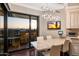 Dining area features floor-to-ceiling windows with city views and custom lighting fixture at 1040 E Osborn Rd # 1801, Phoenix, AZ 85014