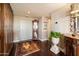 Inviting foyer with rich hardwood floors, decorative rug, and elegant furniture pieces at 1040 E Osborn Rd # 1801, Phoenix, AZ 85014