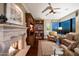 Cozy living room featuring a stone fireplace, hardwood floors, and built-in bookshelves at 1040 E Osborn Rd # 1801, Phoenix, AZ 85014