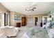 Spacious main bedroom featuring a TV, ceiling fan, and a lounge chair near the window at 1040 E Osborn Rd # 1801, Phoenix, AZ 85014