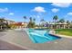 Community pool and lounge area surrounded by palm trees and lush landscaping on a sunny day at 1040 E Osborn Rd # 1801, Phoenix, AZ 85014