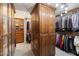 Custom walk-in closet with abundant wooden storage, shelves, and organized hanging spaces at 1040 E Osborn Rd # 1801, Phoenix, AZ 85014