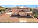 Two-story home exterior with a red tile roof and solar panels, and a large stone landscaped backyard at 10520 W Patrick Ln, Peoria, AZ 85383