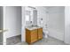 Bathroom with single sink vanity, granite countertop, mirror and tiled floor at 10520 W Patrick Ln, Peoria, AZ 85383