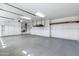 Clean garage with custom storage cabinets, epoxy floor, and overhead lighting at 10520 W Patrick Ln, Peoria, AZ 85383