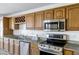 Bright kitchen featuring stainless steel appliances and granite countertops, perfect for cooking at 10520 W Patrick Ln, Peoria, AZ 85383