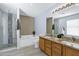 Elegant main bathroom with dual sinks, granite countertop, soaking tub, and a glass-enclosed shower at 10520 W Patrick Ln, Peoria, AZ 85383