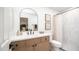 Modern bathroom featuring a vanity with a large mirror, a shower-tub, and clean lines at 10957 E Hope Dr, Scottsdale, AZ 85259