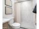 Modern bathroom featuring tiled walk-in shower, neutral color palette, and framed artwork at 10957 E Hope Dr, Scottsdale, AZ 85259