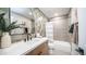 Modern bathroom featuring a vanity, patterned tile, and a shower-tub combination at 10957 E Hope Dr, Scottsdale, AZ 85259