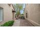 Tile walkway through private courtyard showcasing desert landscaping and stucco exterior at 10957 E Hope Dr, Scottsdale, AZ 85259