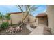 Private courtyard with rock garden, mature desert landscaping and tiled walkway to covered entry at 10957 E Hope Dr, Scottsdale, AZ 85259