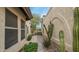 Tile walkway through private courtyard showcasing desert landscaping and stucco exterior at 10957 E Hope Dr, Scottsdale, AZ 85259