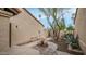 Side courtyard with rock garden, desert landscaping and tiled walkway to covered entry at 10957 E Hope Dr, Scottsdale, AZ 85259