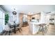 A modern kitchen with stainless steel appliances, a breakfast bar, and an adjacent dining area at 10957 E Hope Dr, Scottsdale, AZ 85259