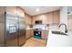 Well-lit kitchen showcasing stainless steel appliances and wood cabinetry at 10957 E Hope Dr, Scottsdale, AZ 85259