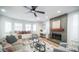 Cozy living room featuring a fireplace, large windows with a bench, and plush seating at 10957 E Hope Dr, Scottsdale, AZ 85259