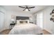 Comfortable main bedroom features neutral tones, hardwood floors, and a window with plantation shutters at 10957 E Hope Dr, Scottsdale, AZ 85259