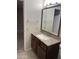 Bathroom featuring modern vanity with granite countertop and a framed mirror at 11001 W Tonada Dr, Sun City, AZ 85351