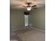 Serene bedroom features a ceiling fan, neutral walls, and a bright window at 11001 W Tonada Dr, Sun City, AZ 85351