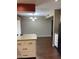 Dining area with chandelier and hardwood floors next to the kitchen and black refrigerator at 11001 W Tonada Dr, Sun City, AZ 85351