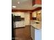 Well-lit kitchen featuring white cabinetry, stainless steel appliances, and hardwood flooring at 11001 W Tonada Dr, Sun City, AZ 85351